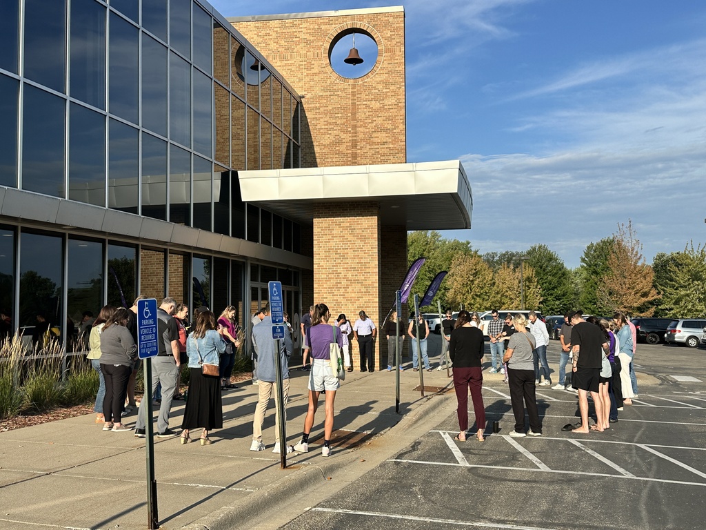 a group of parents gathered outside to pray for our school