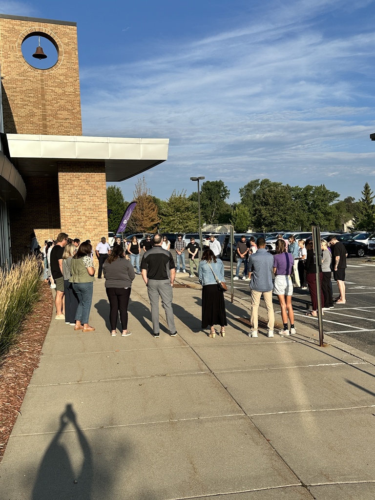 a group of parents gathered outside to pray for our school