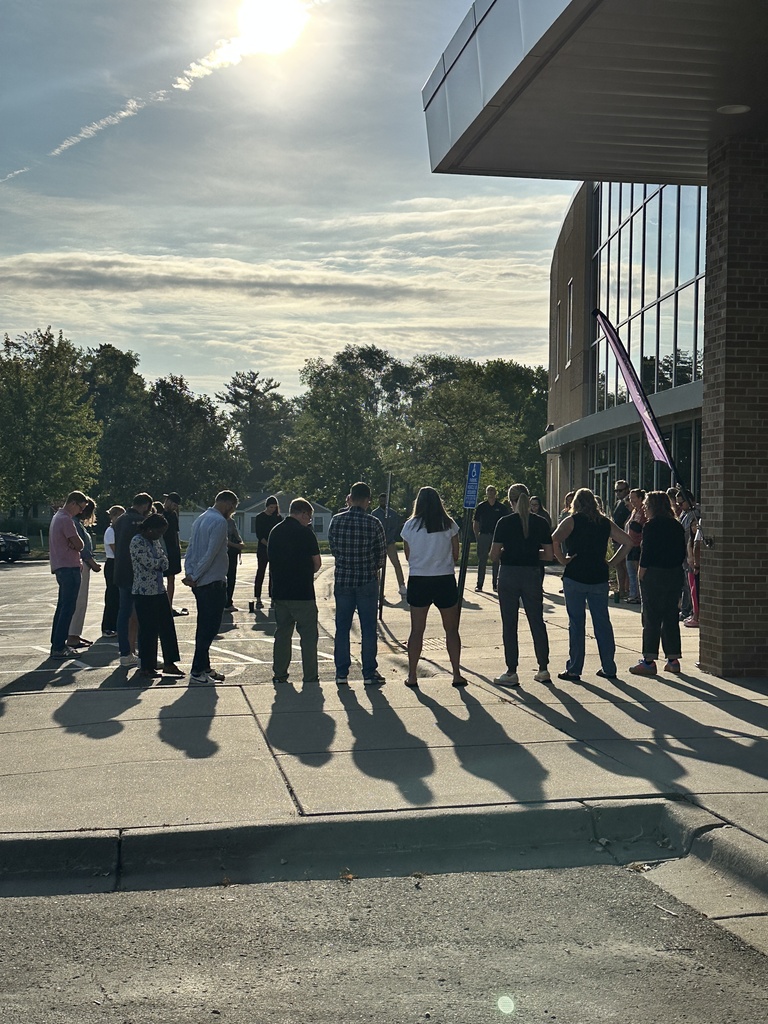 a group of parents gathered outside to pray for our school