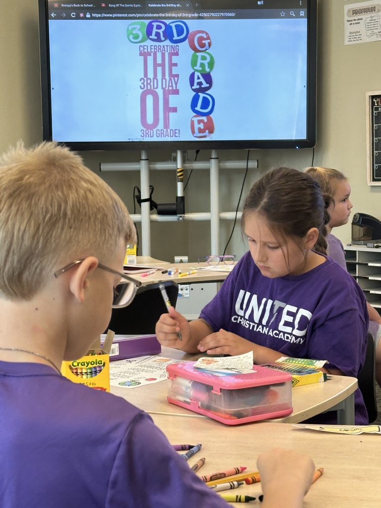 students at their desk coloring