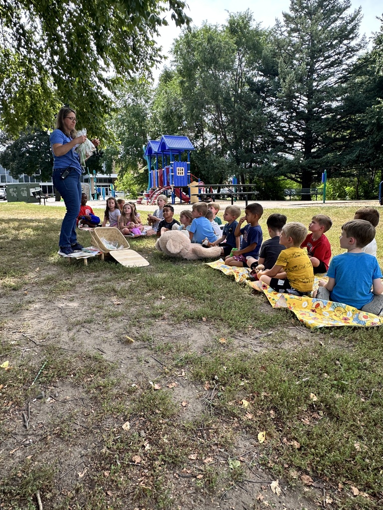 kindergarten class sitting outside having a picnic