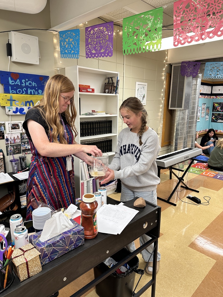 teacher handing her student some food