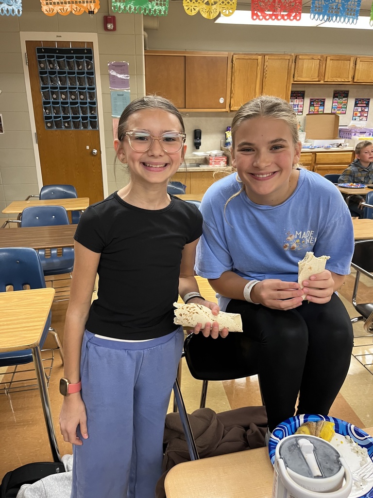 two girls eating burritos
