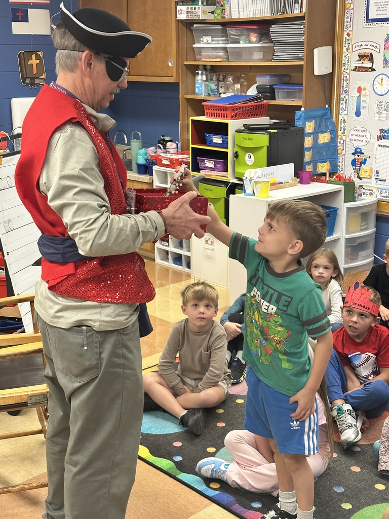 student picking a treasure out of a box