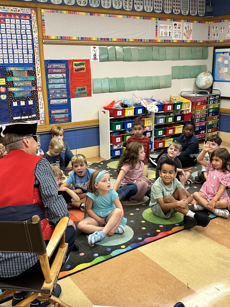 Principal dressed as a pirate talking to a classroom of kindergarten students