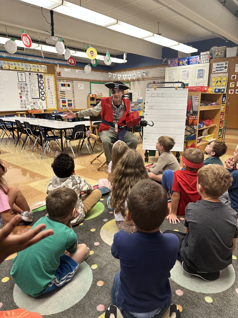 Principal dressed as a pirate talking to a classroom of kindergarten students