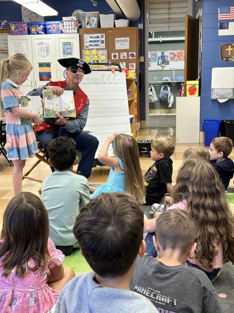 principal reading a story to the class