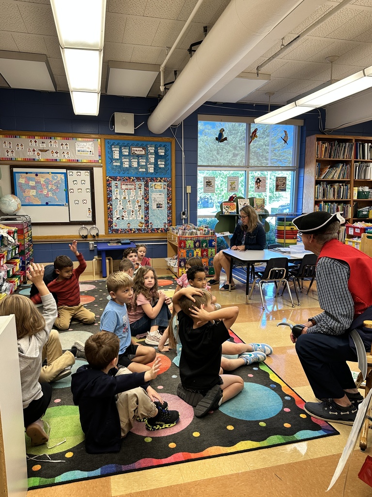 Principal dressed as a pirate talking to a classroom of kindergarten students