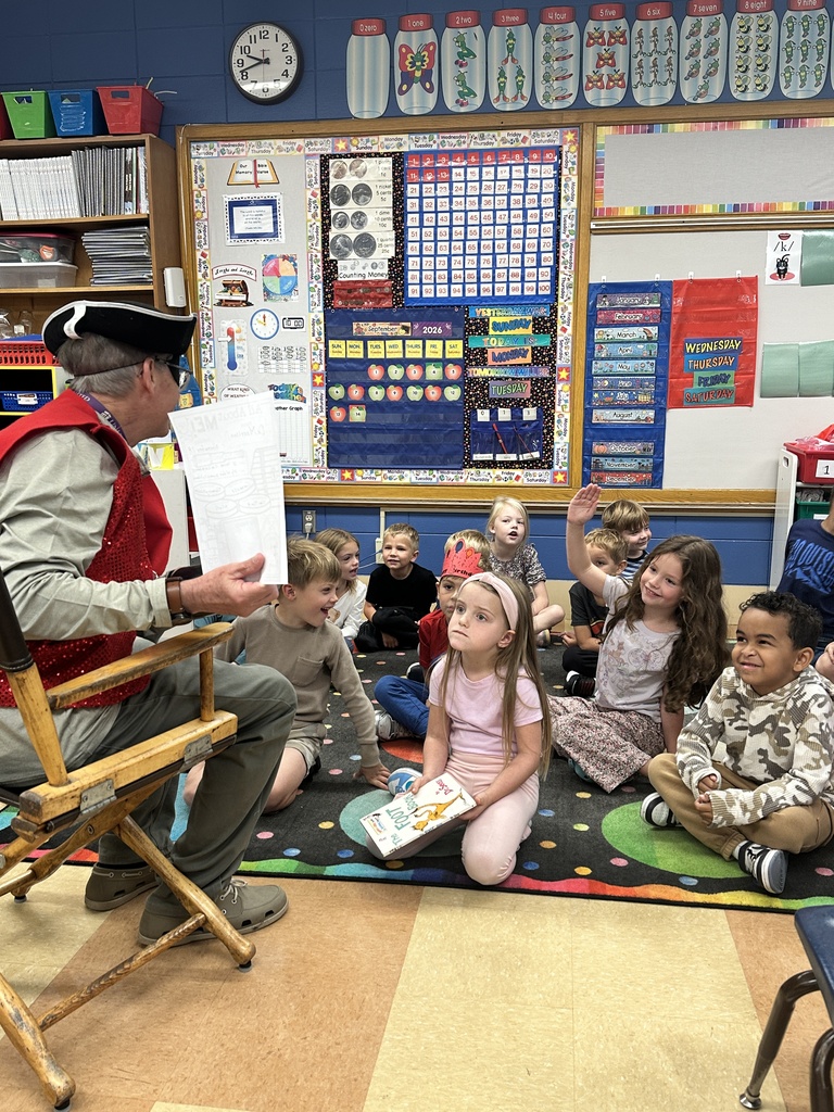 Principal dressed as a pirate talking to a classroom of kindergarten students