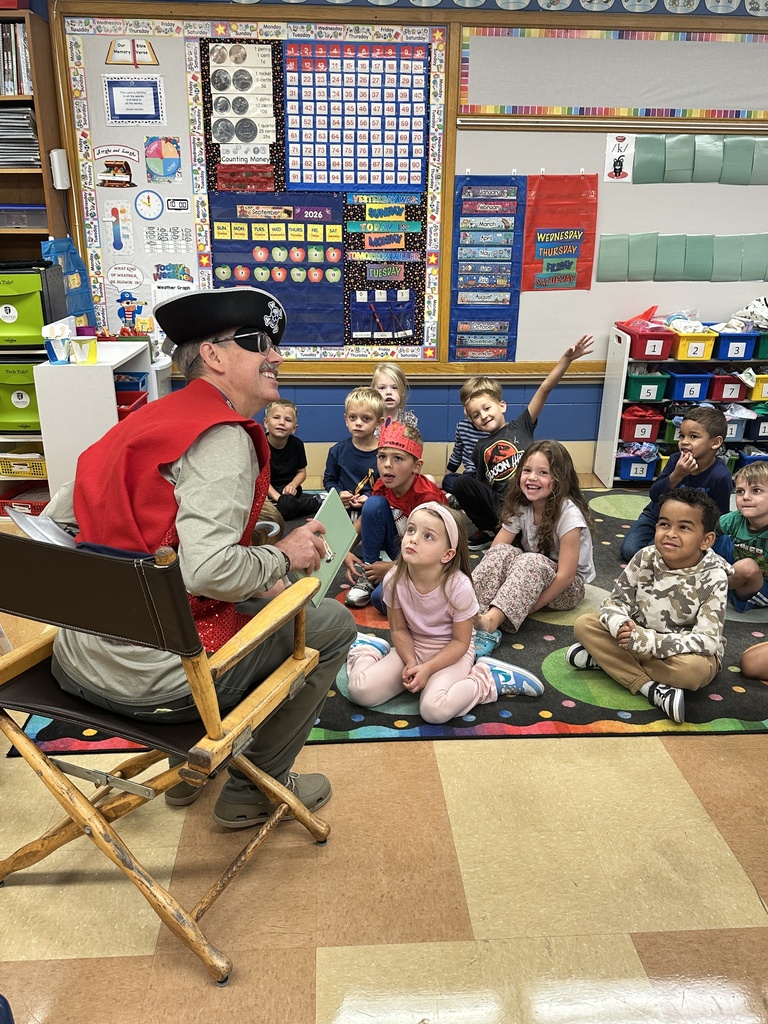 Principal dressed as a pirate talking to a classroom of kindergarten students