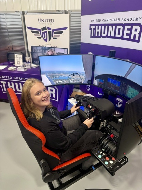 woman sitting at a flight simulator