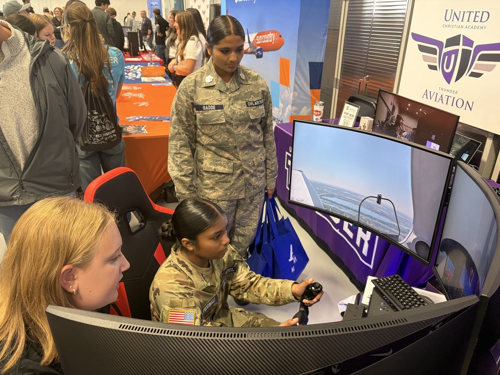 three girls on a flight simulator