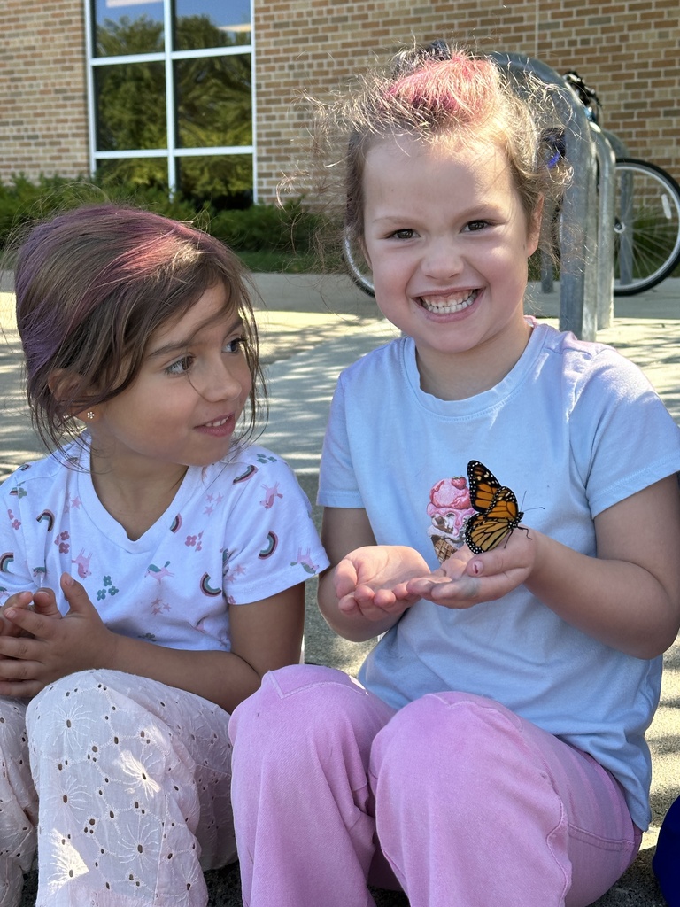 kindergarten students holding a monarch butterfly