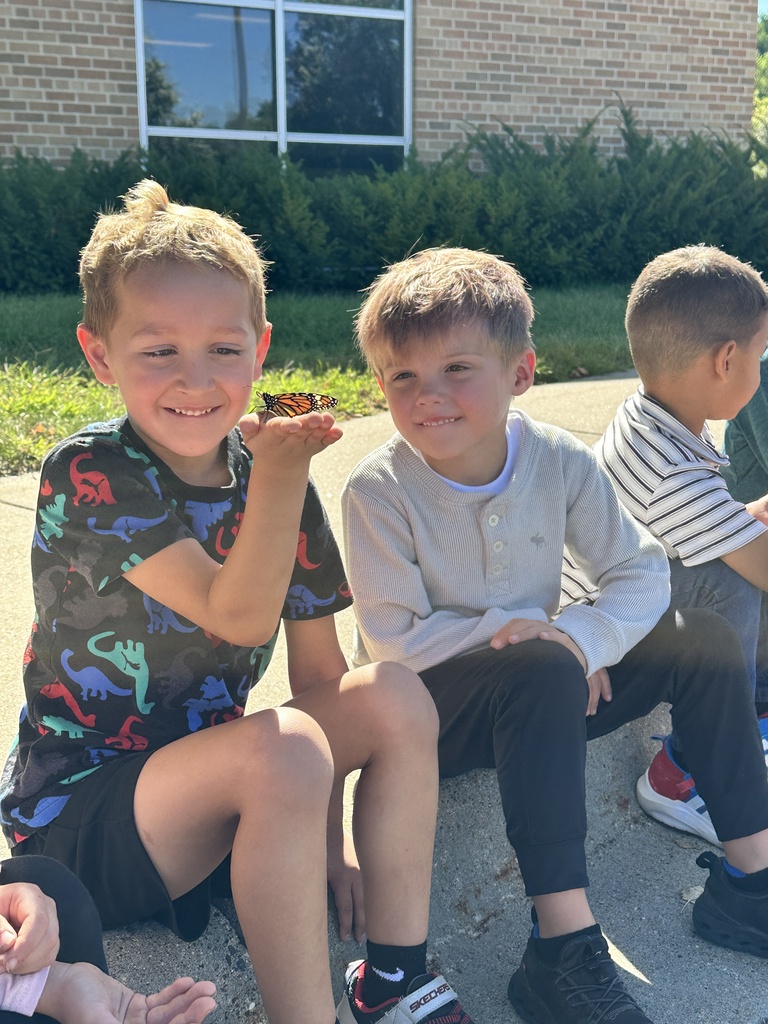 kindergarten students holding a monarch butterfly