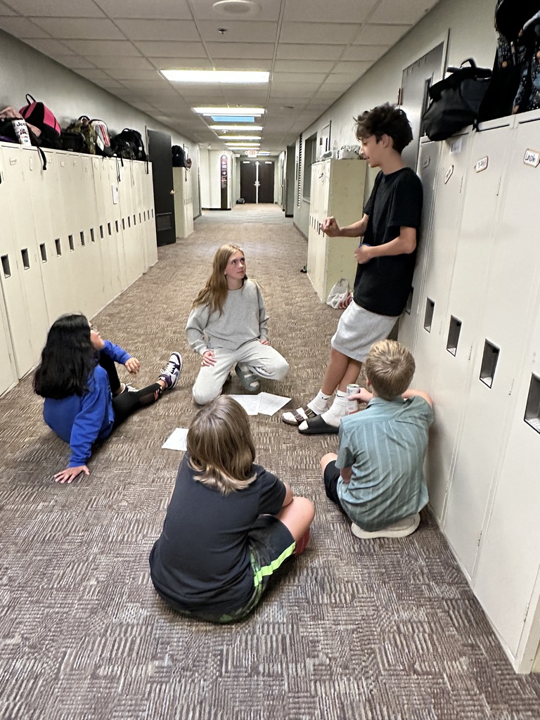 students acting as the jury sitting in the hallway talking