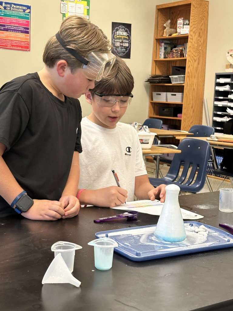 students recreating an eruption in a science experiment