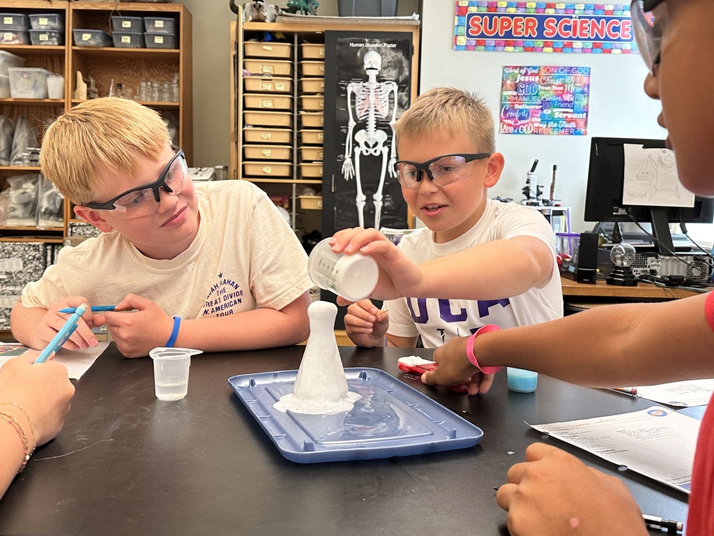 students recreating an eruption in a science experiment