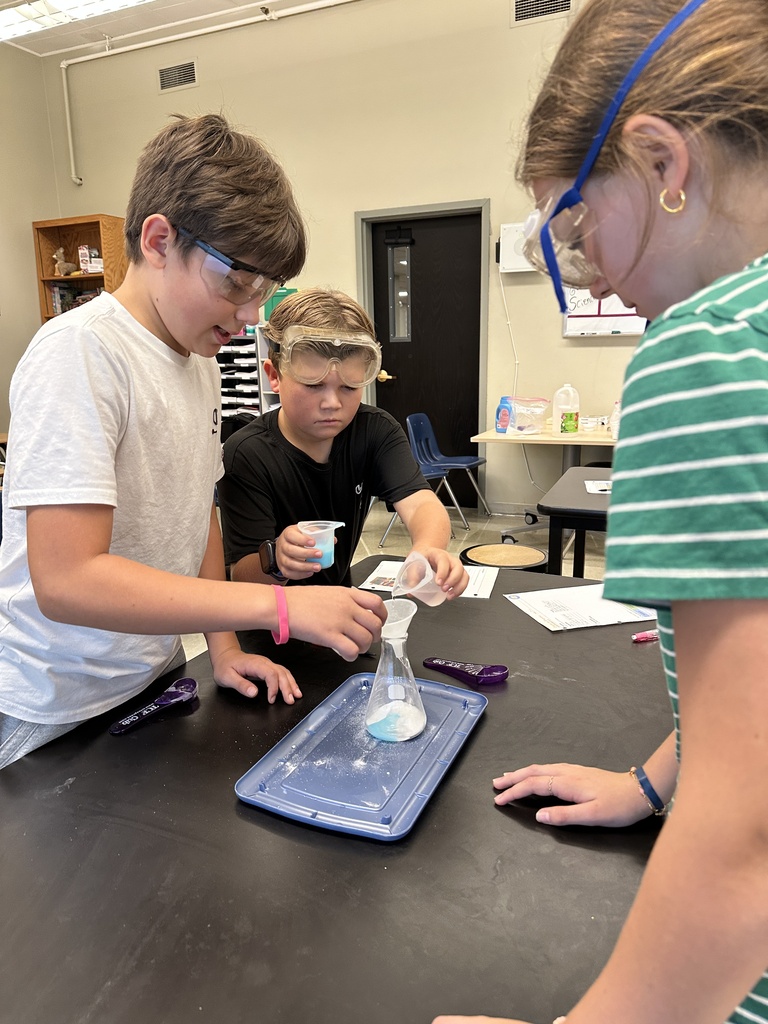 students recreating an eruption in a science experiment