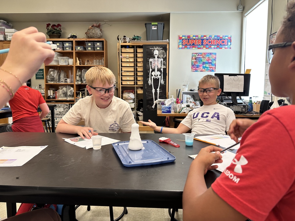 students recreating an eruption in a science experiment