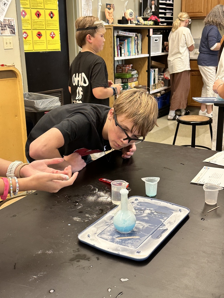 students recreating an eruption in a science experiment