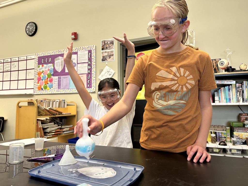 students recreating an eruption in a science experiment