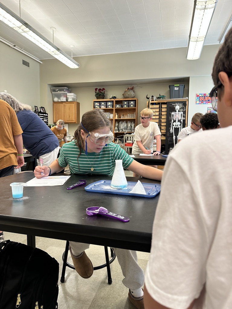 students recreating an eruption in a science experiment