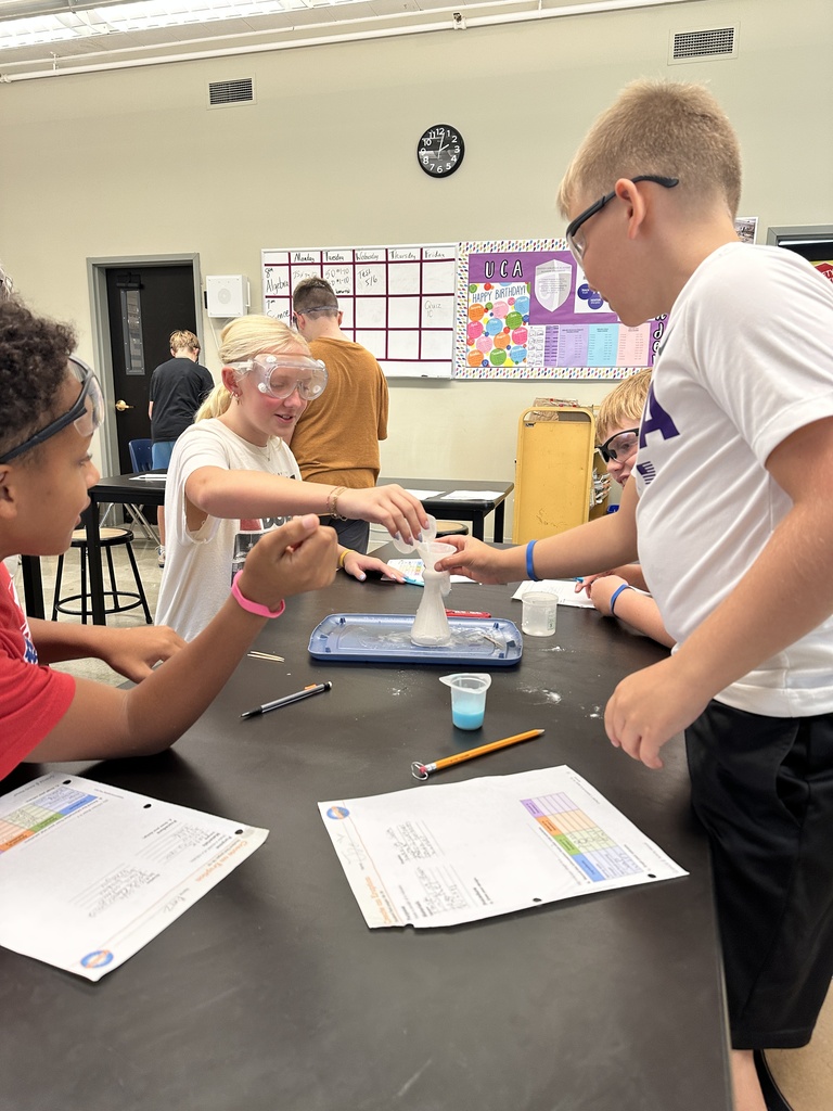 students recreating an eruption in a science experiment
