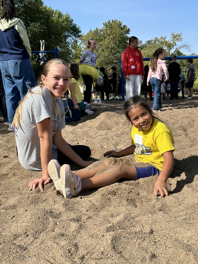 two students playing in the sand