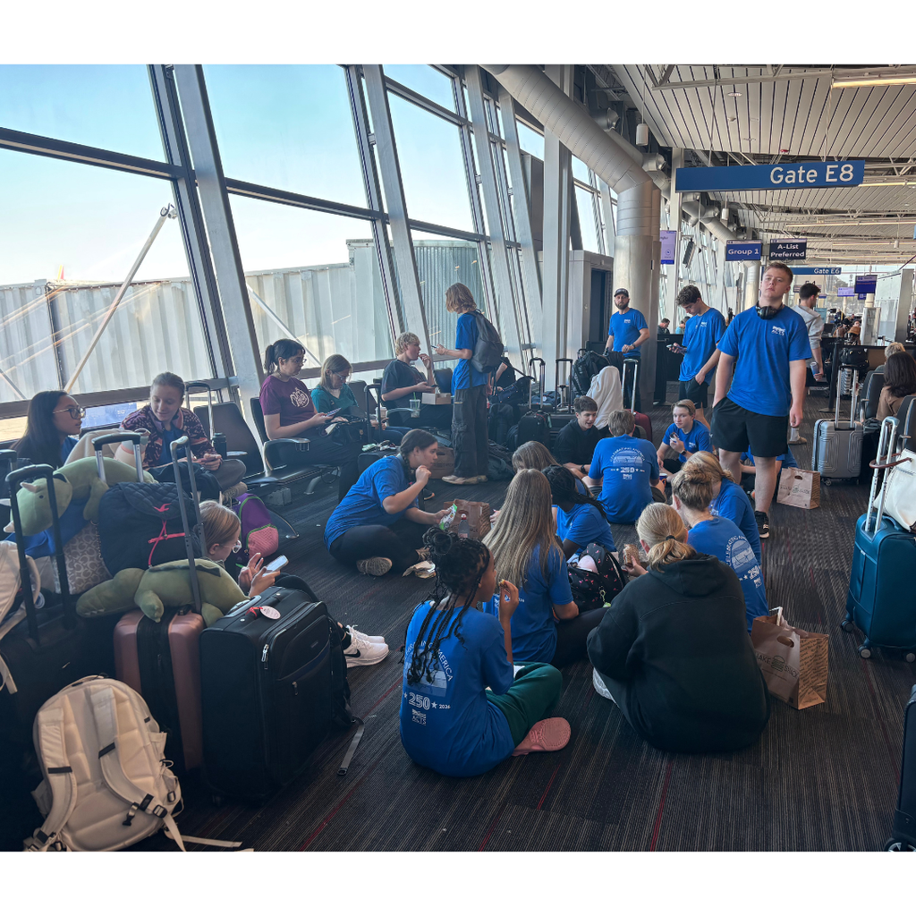 group of travelers waiting at the gate in an airport