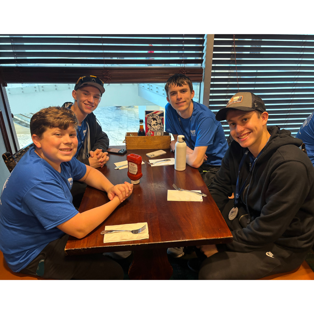 group of boys at a table in a restaurant