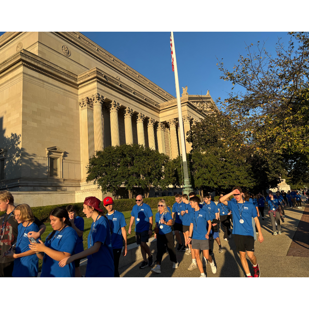 group of students walking on the sidewalk
