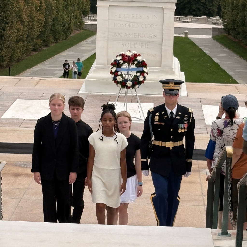students walking up stairs with a military officer