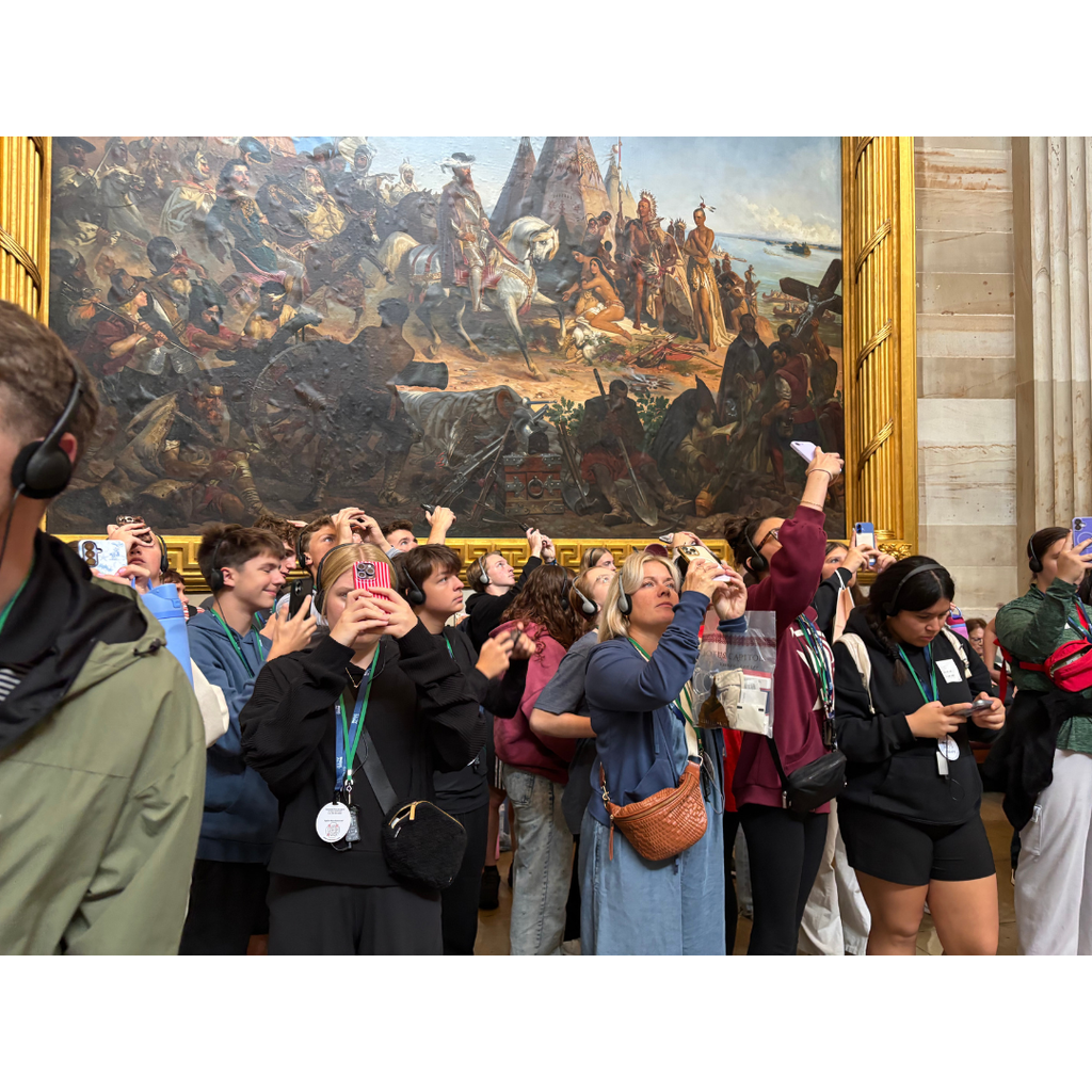 students on a tour taking pictures