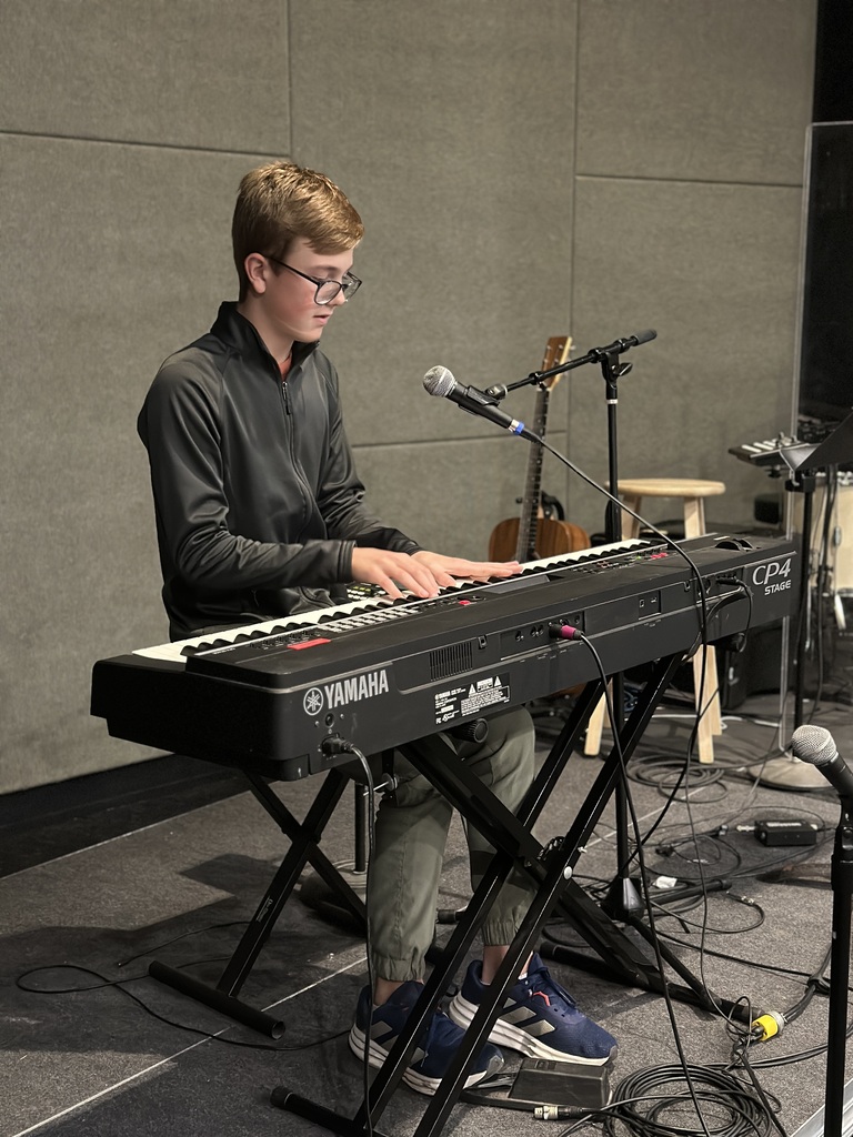 teenage boy playing piano