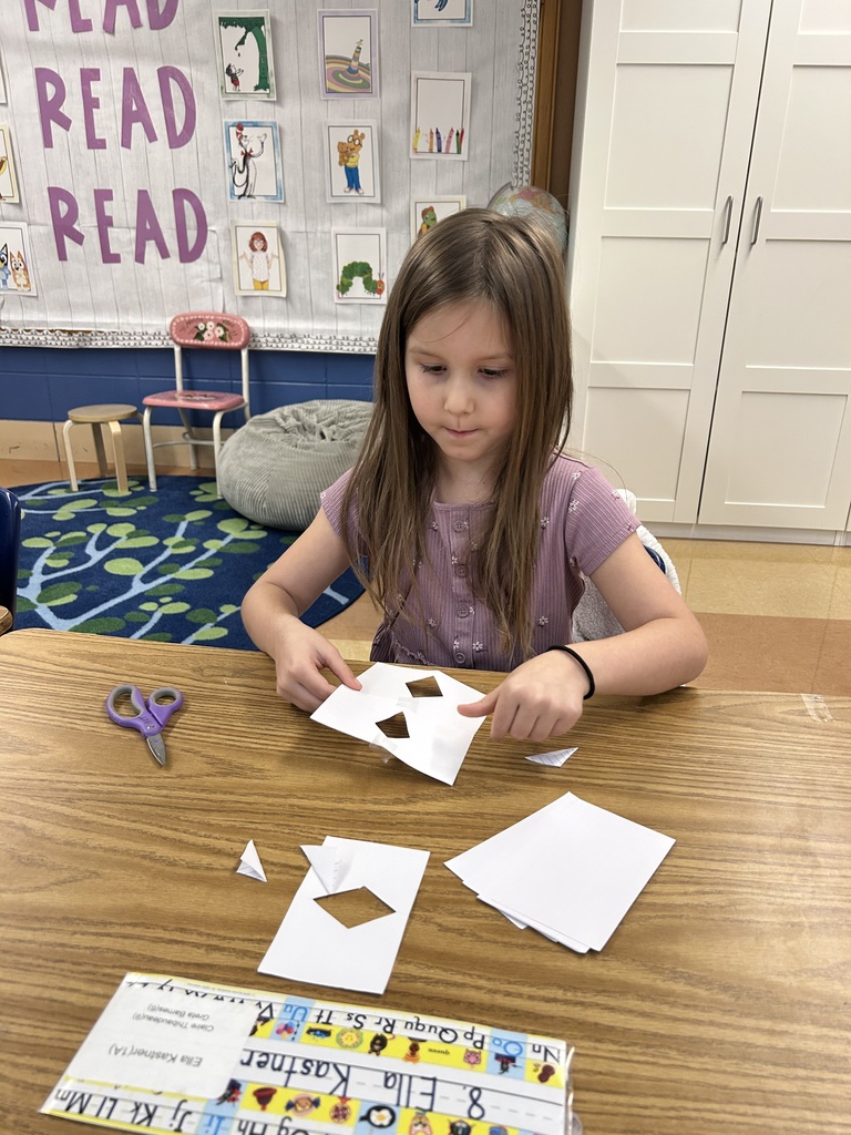 student building a tower out of notecards
