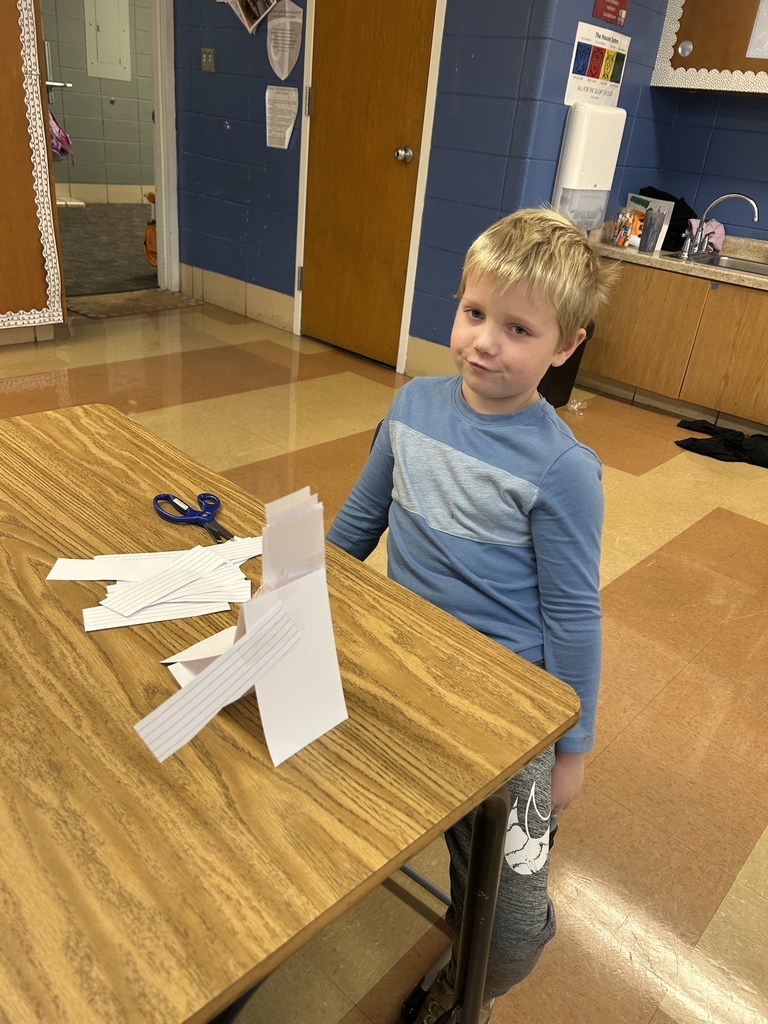 student building a tower out of notecards
