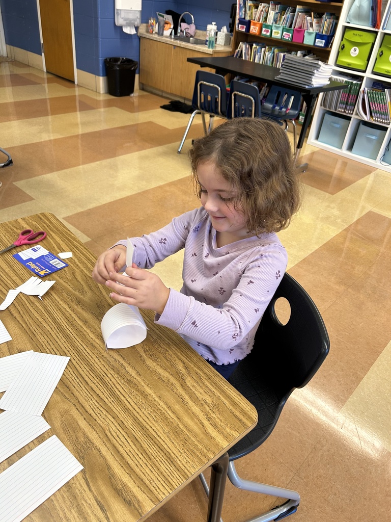 student building a tower out of notecards