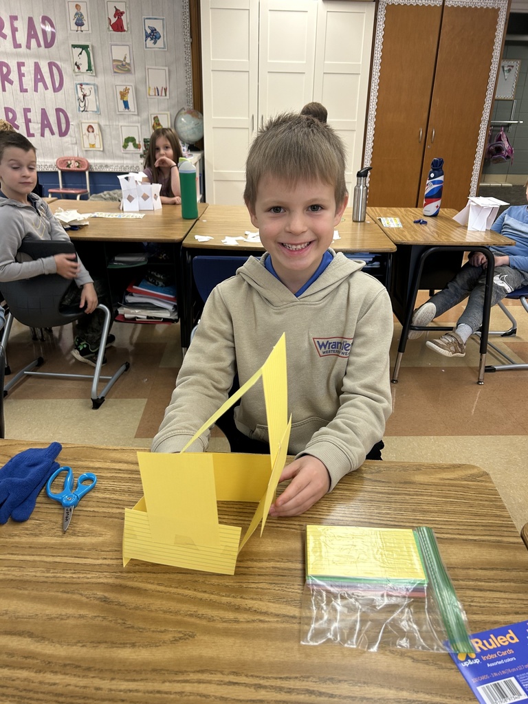 student building a tower out of notecards