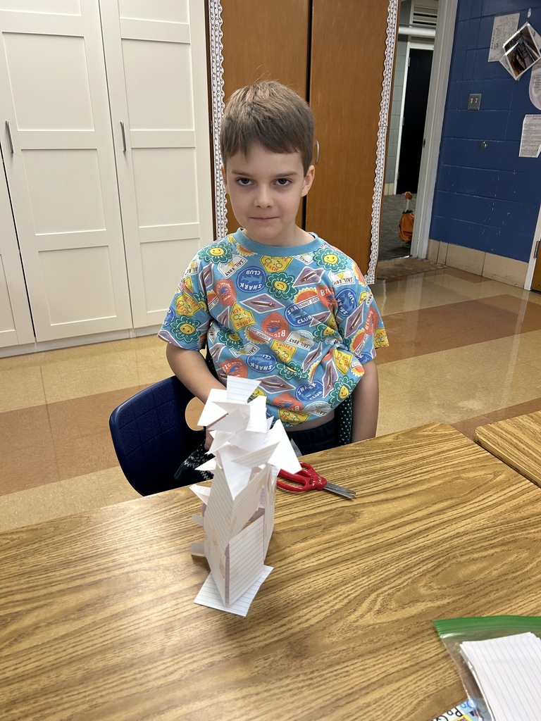 student building a tower out of notecards