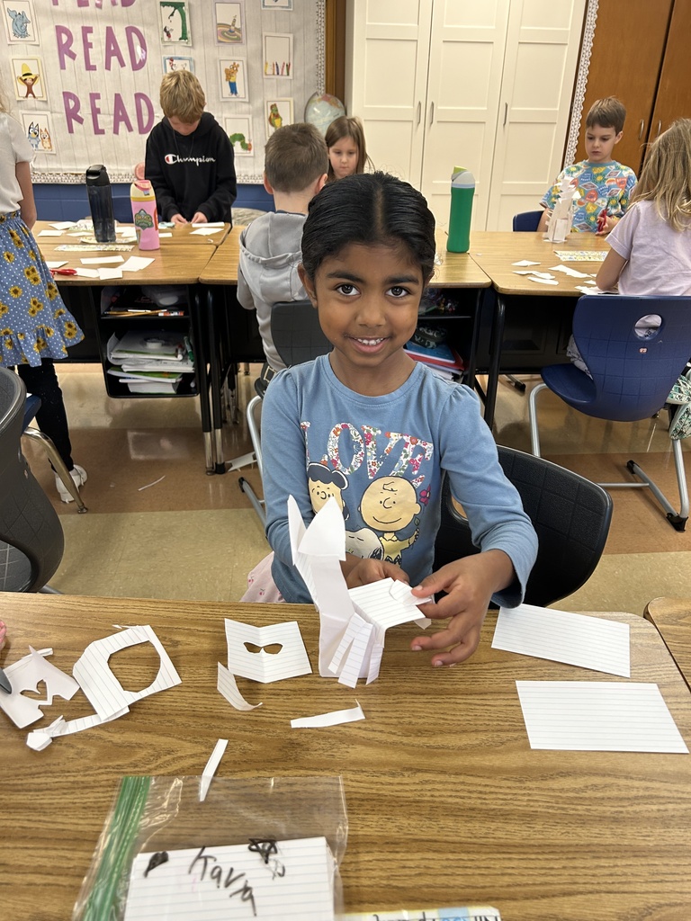 student building a tower out of notecards