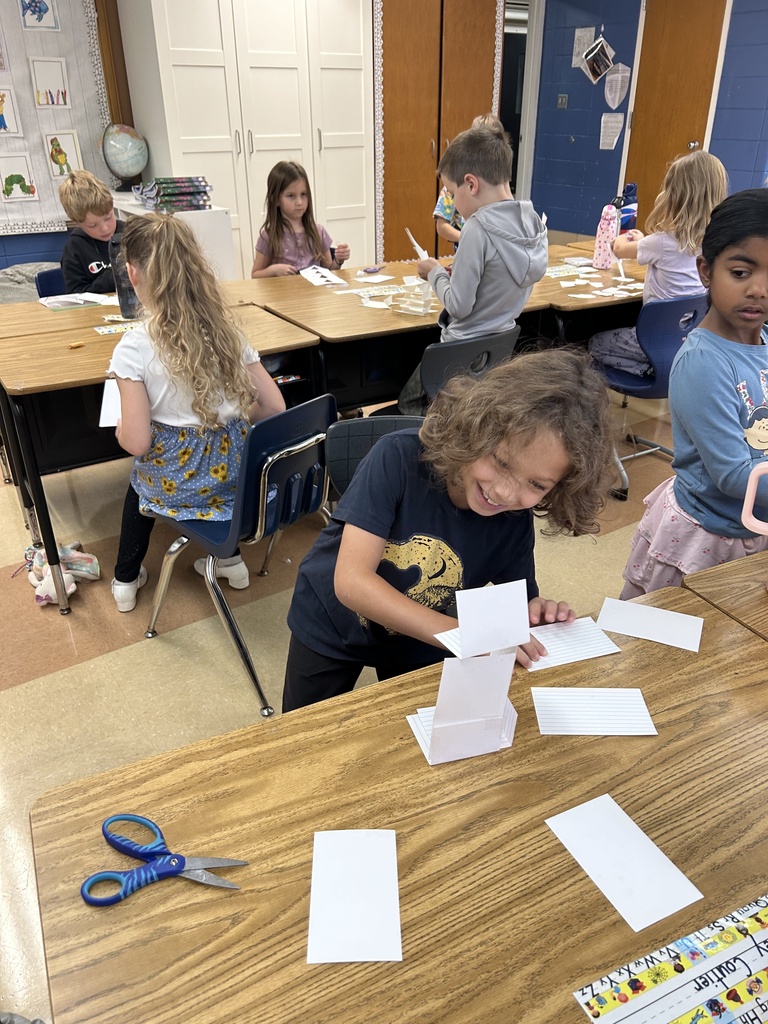 student building a tower out of notecards