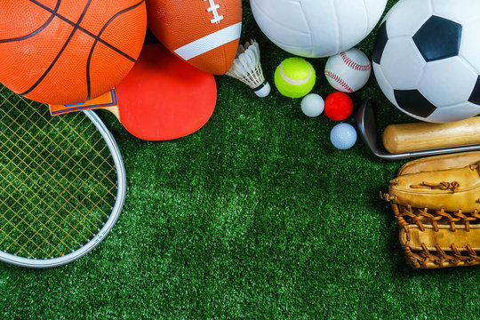 A variety of sports equipment lying on green turf, including a basketball,  racquet, ping pong paddle, football, shuttlecock, tennis ball, volleyball, baseball, ping pong balls, soccer ball, golf ball, baseball bat, and golf club. This image accompanies notification of sports summer camp options.