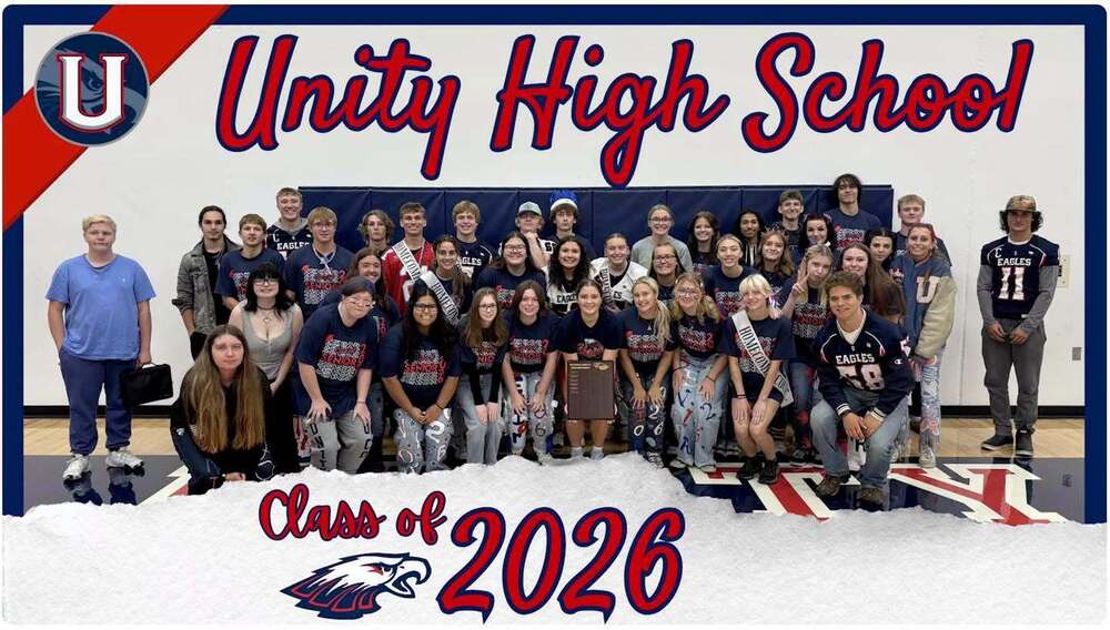 Group photo of the Unity High School Class of 2026 students posing together on a gymnasium floor, featuring the school logo, an eagle mascot, and "Unity High School" text.