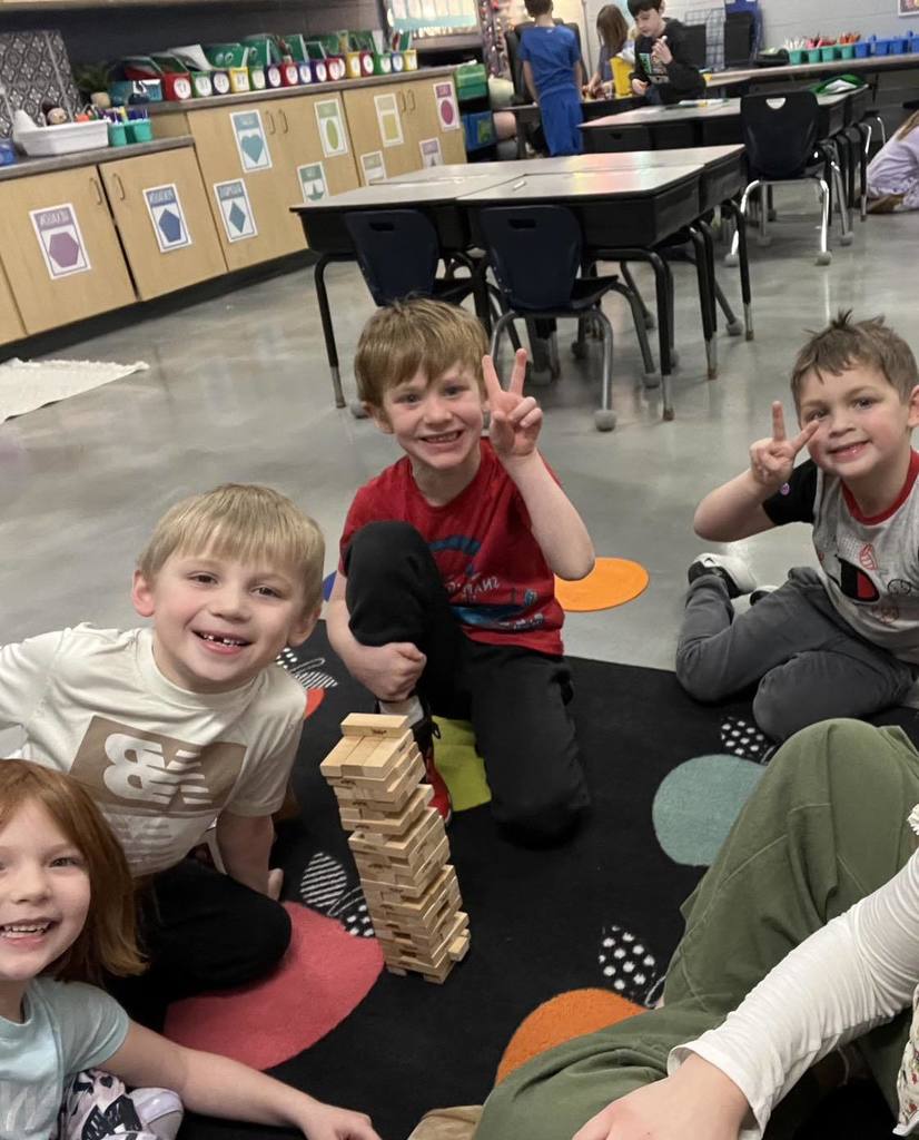 pictures of smiling children playing the game Jenga during inside recess