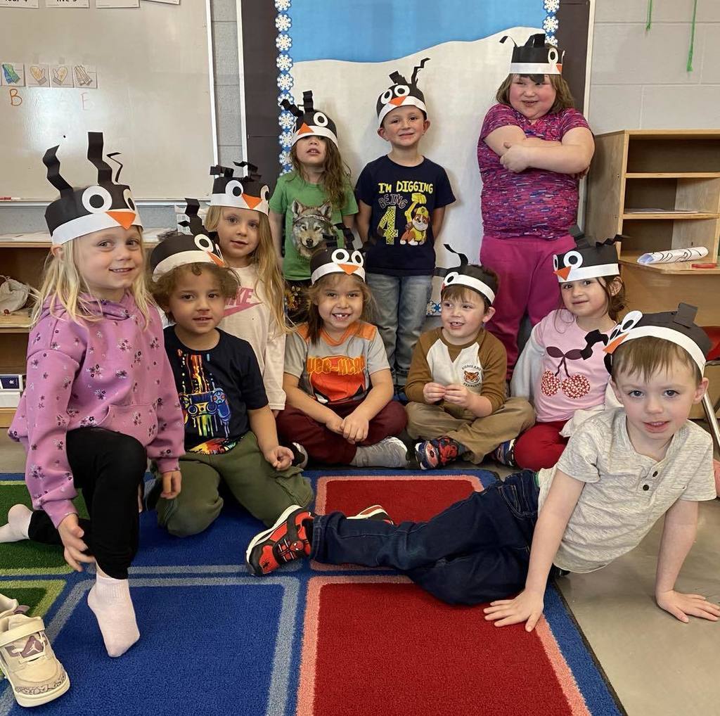 picture of busy bugs class with their homemade penguin hats