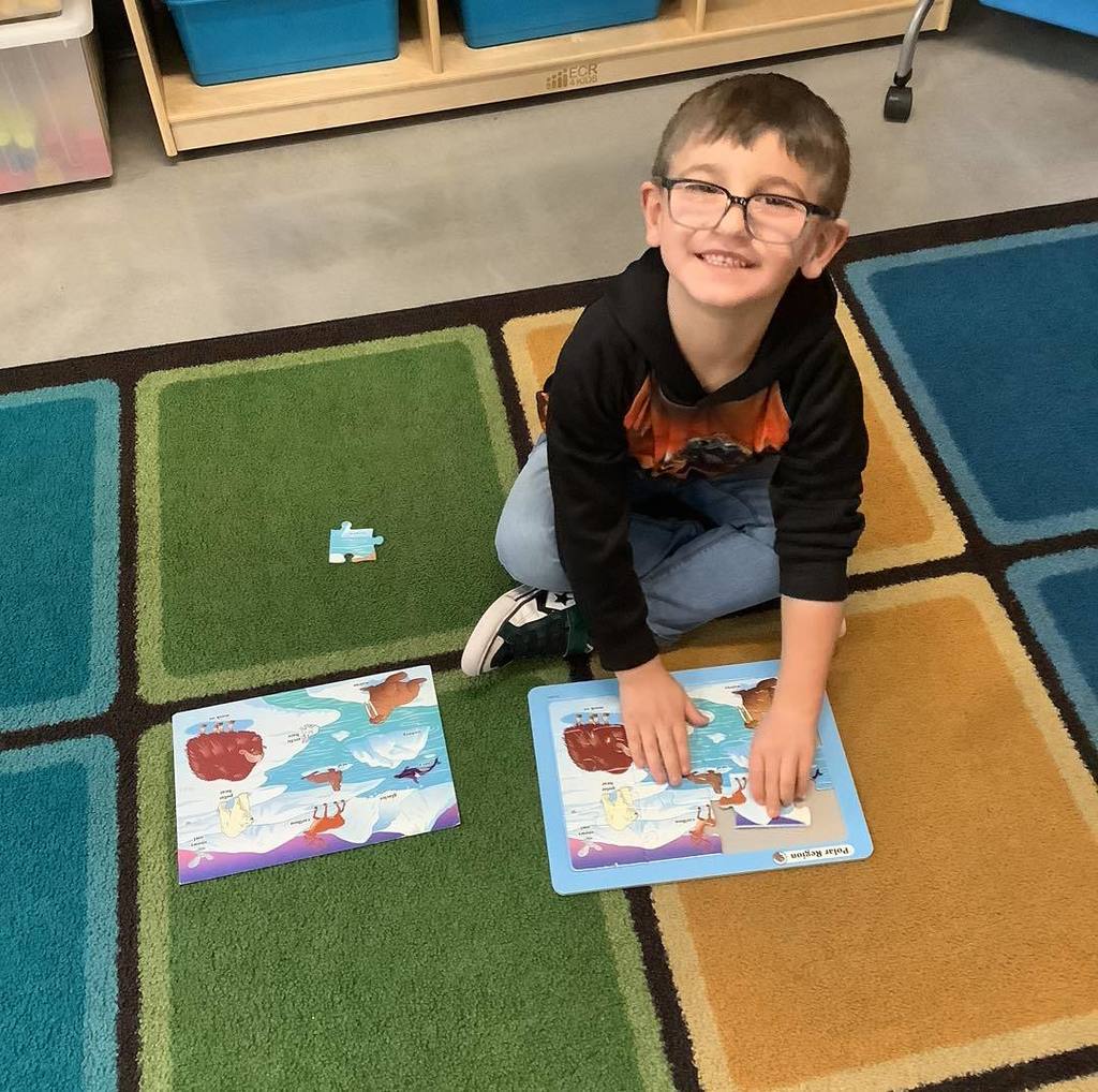 picture of child putting together a puzzle