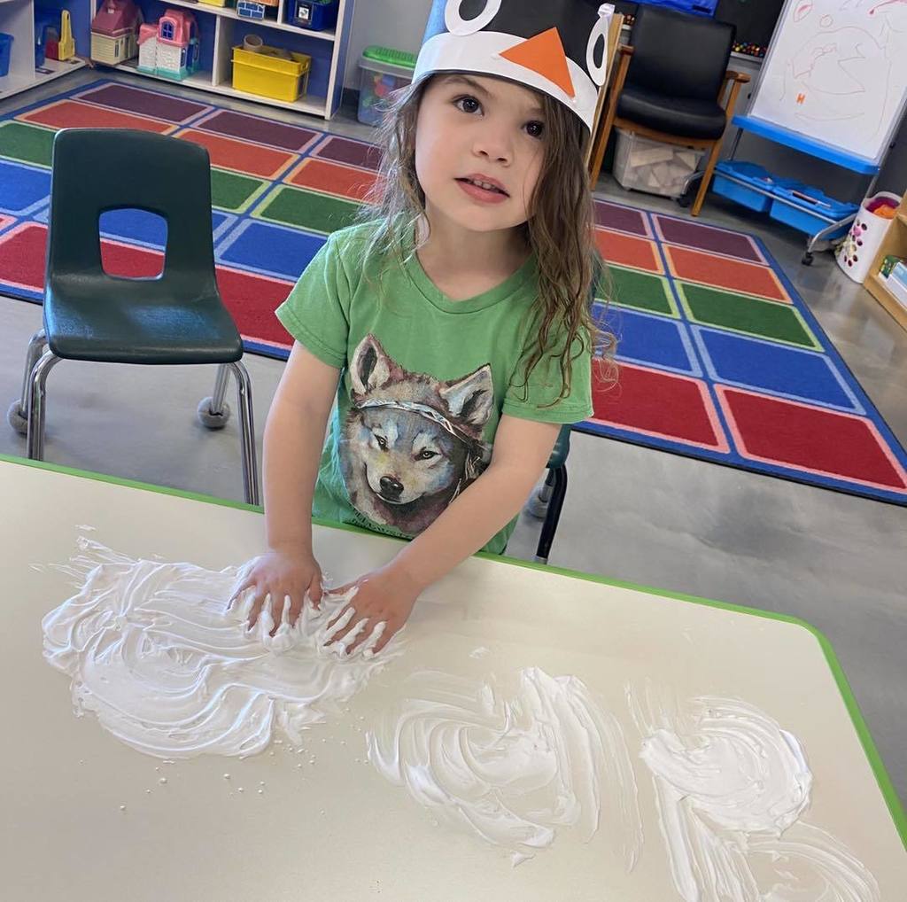 picture of a child finger painting with shaving cream