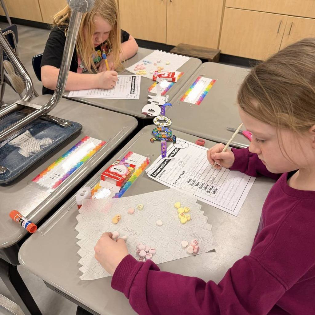 picture of two student learning with candy hearts