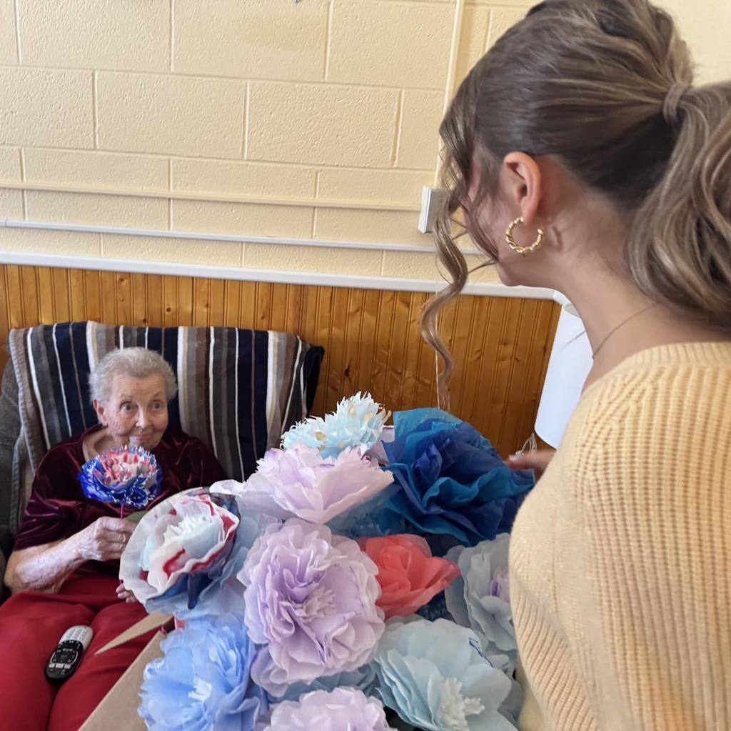 picture of woman receiving paper flowers