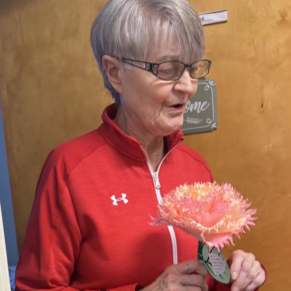 picture of woman holding a flower